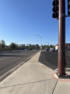 Image of Independence Street looking towards Ralston Road, showing a sidewalk next to a parking lot.