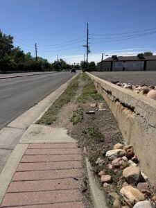 Photo of current Ralston Road sidewalk in the project area, which is damaged at the corner and turns into dirt.
